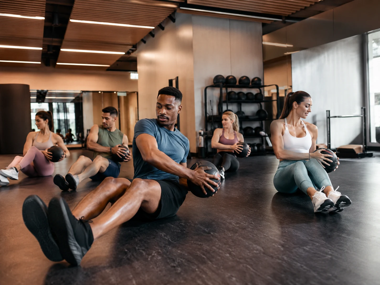 Small group fitness class doing core training